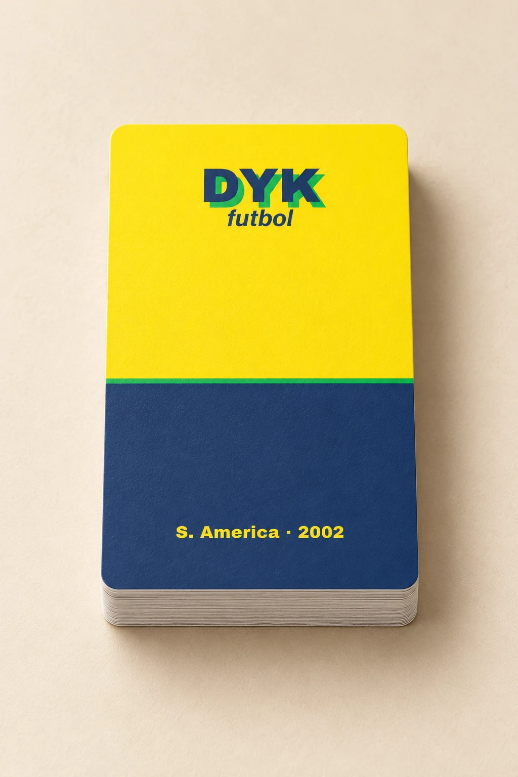 Close detail of the yellow and navy 2002 card with rounded corners and pale paper edges